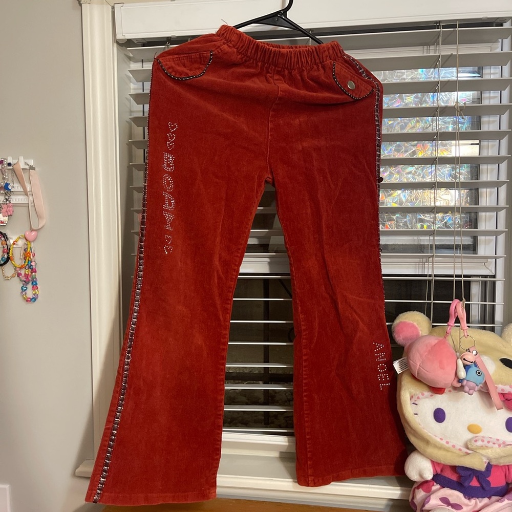 Corduroy red kids pants with ribbon like trim on the side with bell bottoms